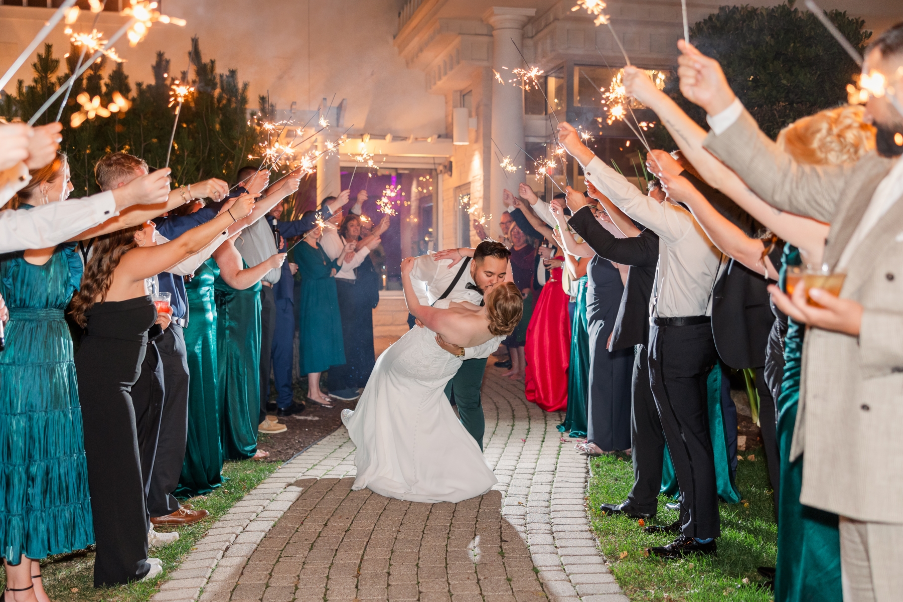 A sparkler send-off through a tunnel of guests