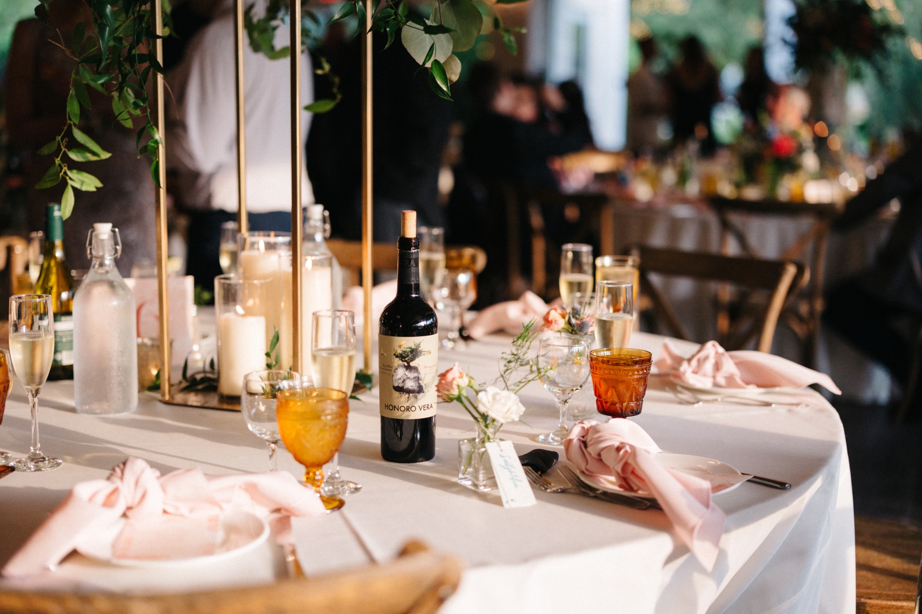 A candlelit tablescape with glassware and wine
