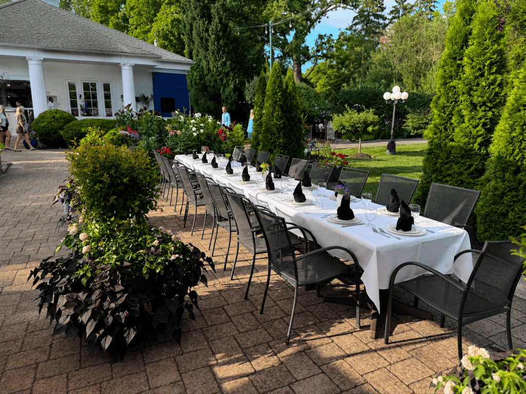 A long table set for a private party on the brick patio